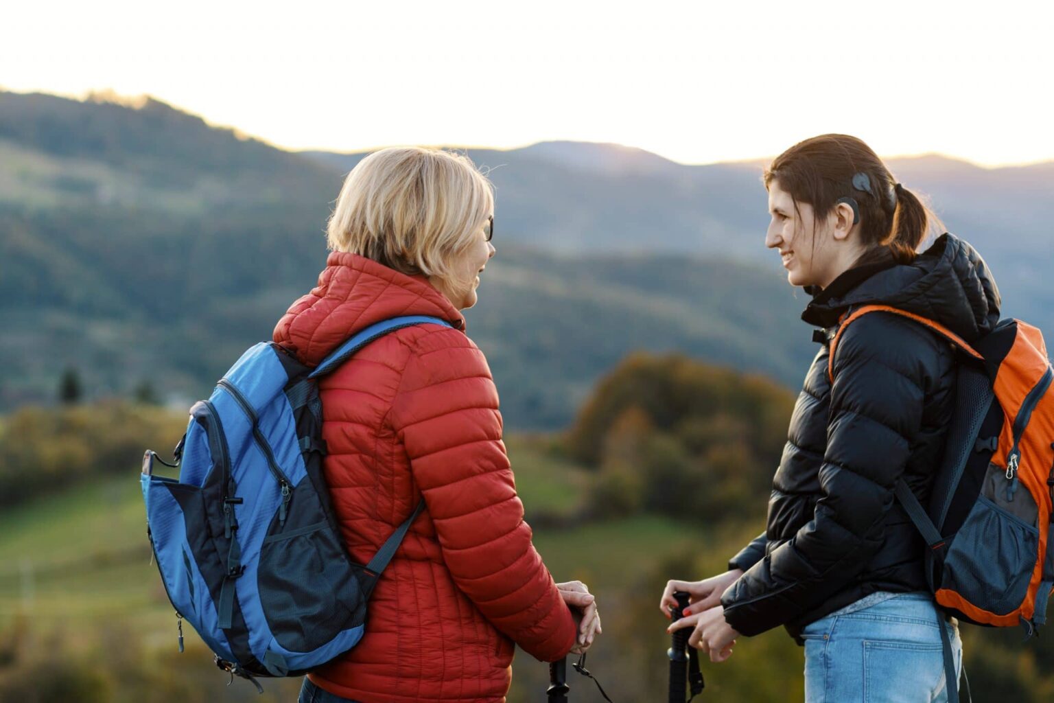 Implantable Hearing Aids Cochlear Implants Woman with implantable hearing aid on a hike with their mother